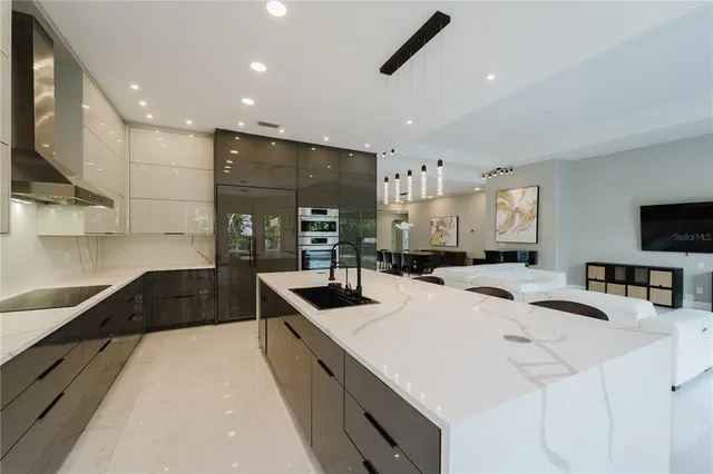 a kitchen with counter top space a sink stainless steel appliances and cabinets