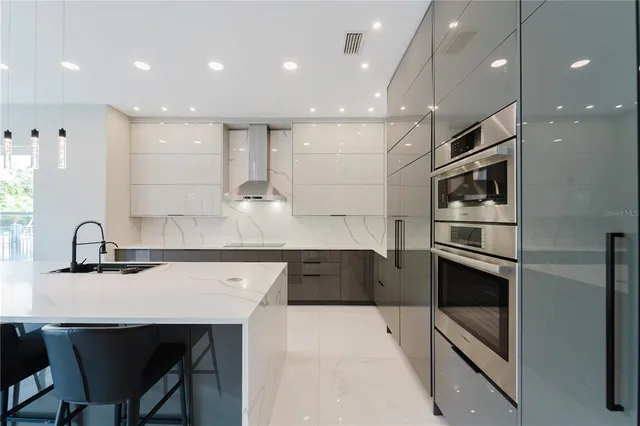 a kitchen with a sink stainless steel appliances and cabinets