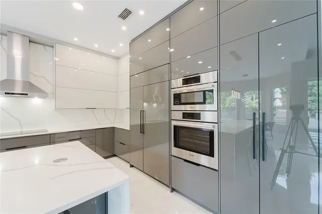 a kitchen with stainless steel appliances a refrigerator and a sink