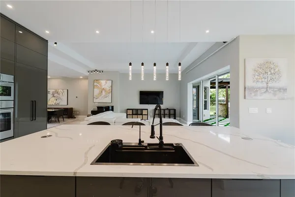 a kitchen with a sink a counter and a refrigerator