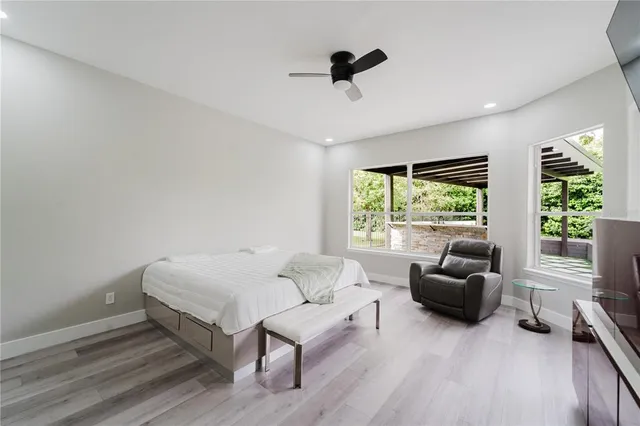 a bedroom with a bed and glass window