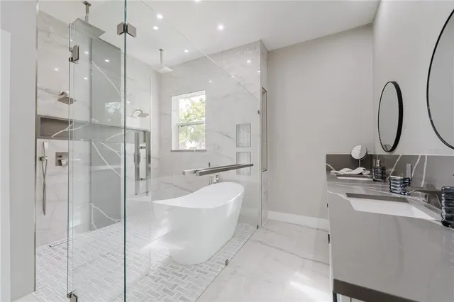 a spacious bathroom with a double vanity sink a mirror and a shower