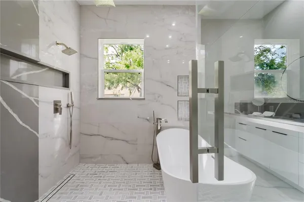 a bathroom with a granite countertop sink a toilet and shower