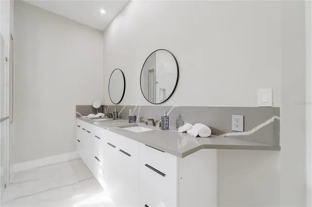 a bathroom with a double vanity sink and a mirror