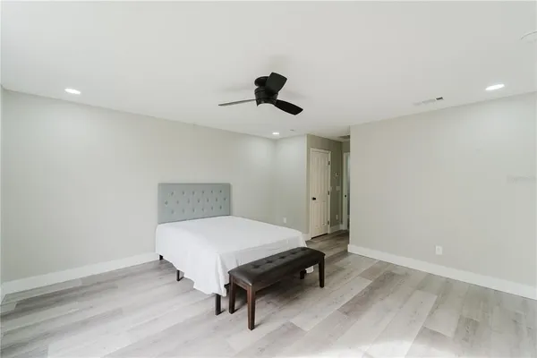 a bedroom with a bed and a chandelier