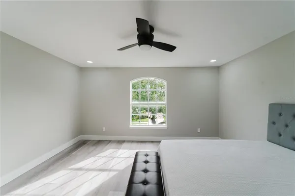 a bedroom with a large bed and a window