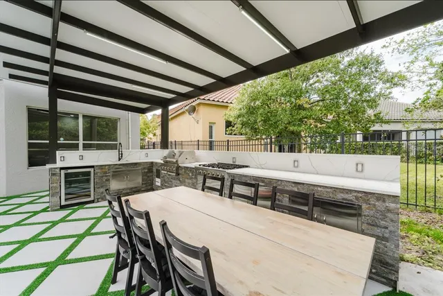 a view of a patio with table and chairs with wooden floor and fence