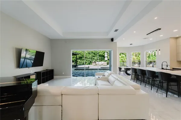 a kitchen with a large window and furniture