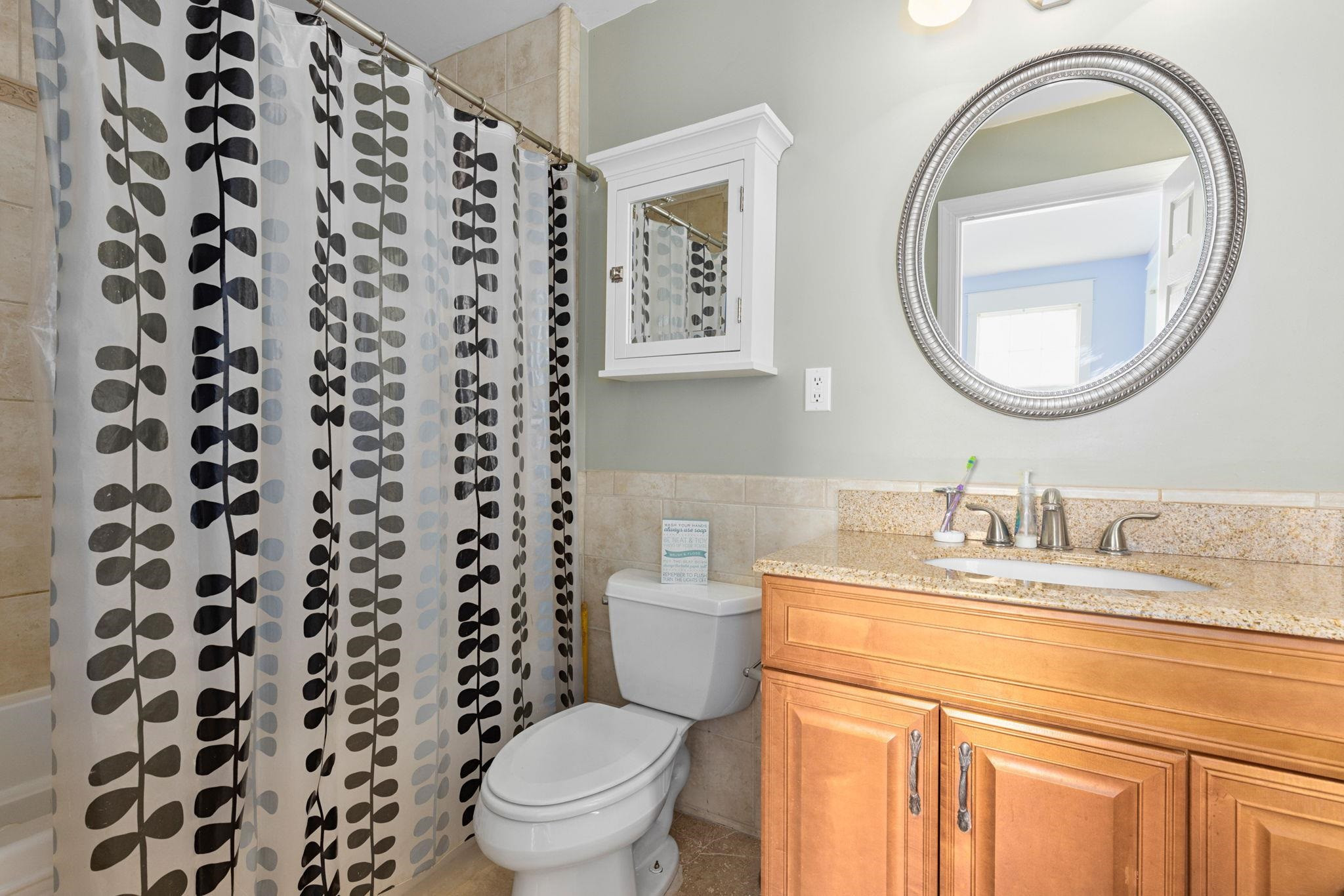 330 Pershing Road Raleigh, NC 27608 - Photo 21 of 51 The en suite bath offers marble tile flooring, a large cabinet vanity with granite countertop and a shower/tub combination with tile surround. En Suite Bath