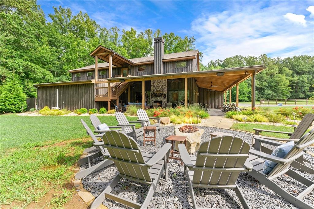 253 Happy Trails Way Jasper, GA 30143 - Photo 19 of 97 a view of a patio with table chairs and a floor to ceiling window
