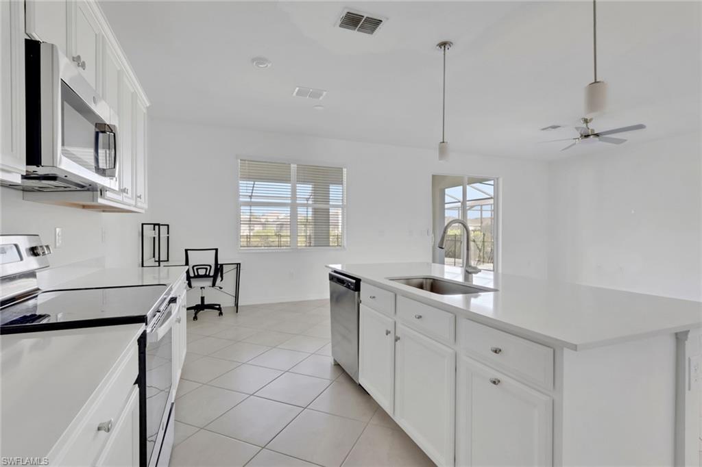 2553 Kona Way Naples, FL 34120 - Photo 11 of 27 a kitchen with cabinets and window