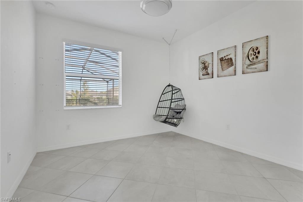 2553 Kona Way Naples, FL 34120 - Photo 13 of 27 an empty room with windows and cabinet