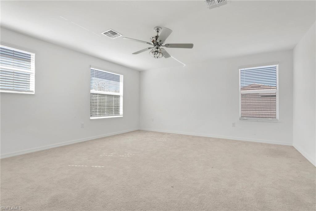 2553 Kona Way Naples, FL 34120 - Photo 15 of 27 an empty room with windows and ceiling fan