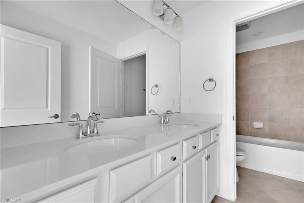 2553 Kona Way Naples, FL 34120 - Photo 16 of 27 a bathroom with double sink and a mirror