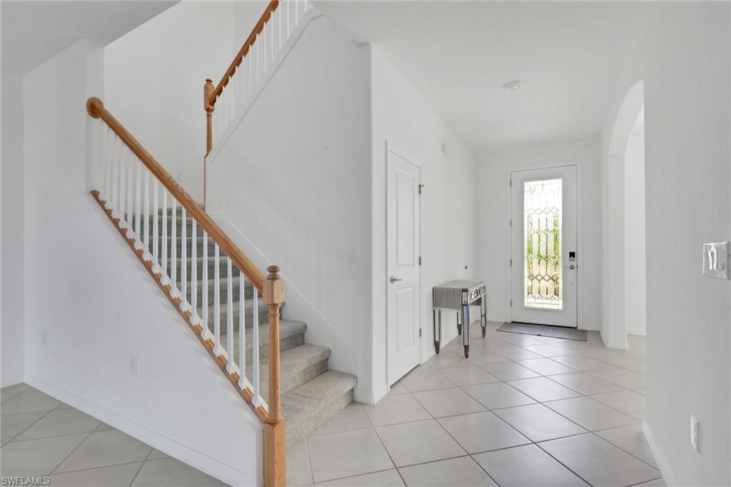2553 Kona Way Naples, FL 34120 - Photo 9 of 27 a view of a hallway with white walls and stairs