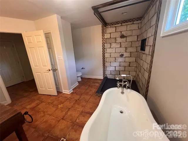 a bathroom with a bathtub and shower