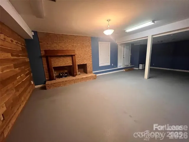 a view of an empty room with a fireplace
