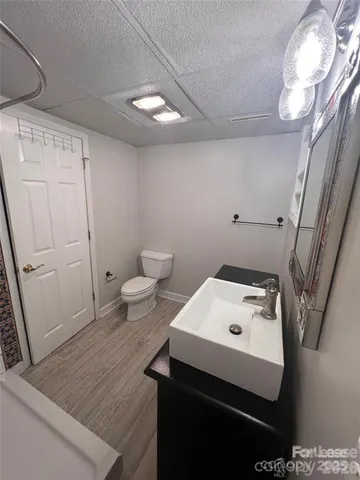 a bathroom with a sink toilet and a mirror