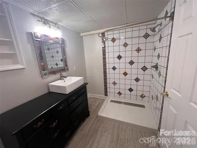 a bathroom with a double vanity sink toilet and shower