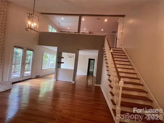 a view of an entryway with wooden floor