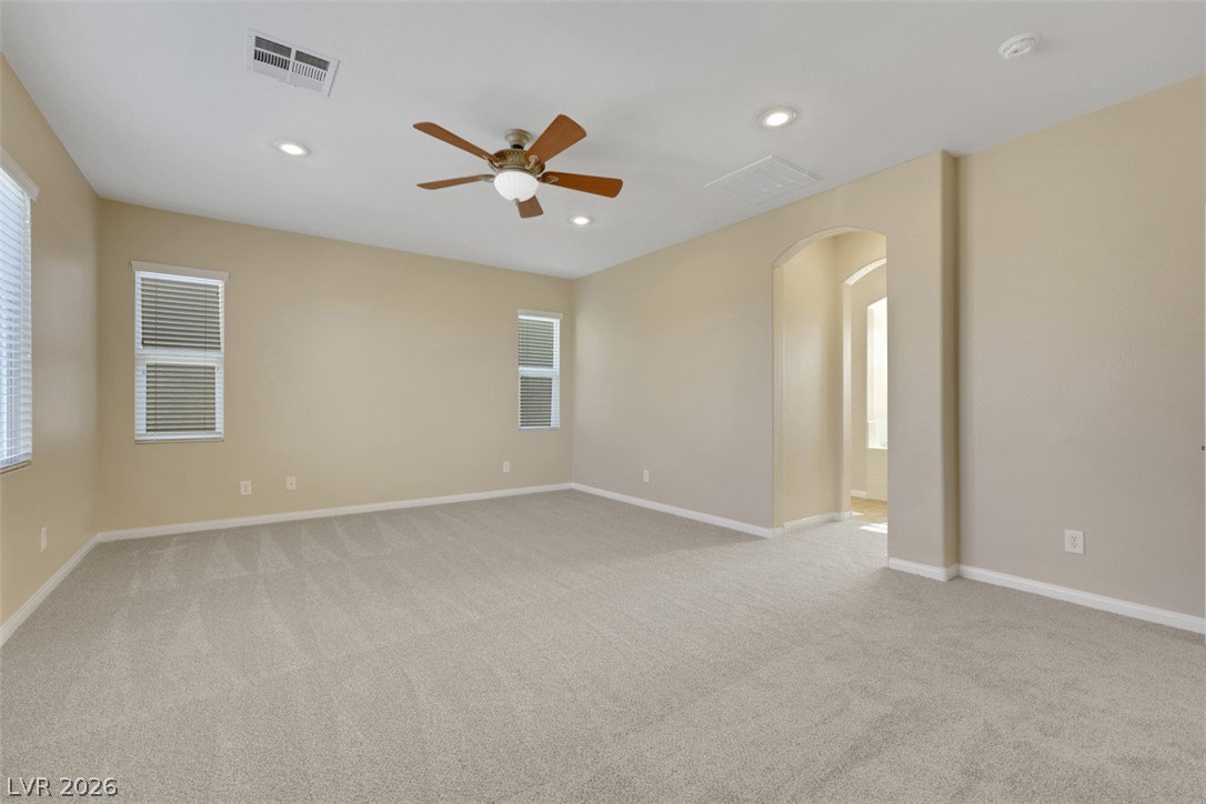 10328 Hawk Ravine Street Las Vegas, NV 89178 - Photo 38 of 55 A spacious room offers comfortable carpet flooring and abundant overhead lighting.