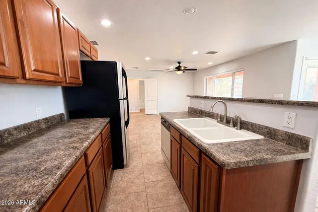 a kitchen with a sink stove and refrigerator