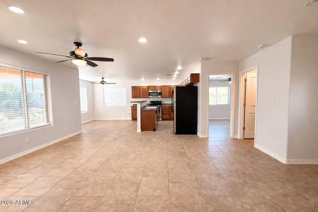 a view of a kitchen with a stove cabinets a ceiling fan and a kitchen view