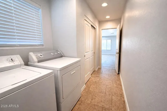 a view of a hallway with white walls and a white door