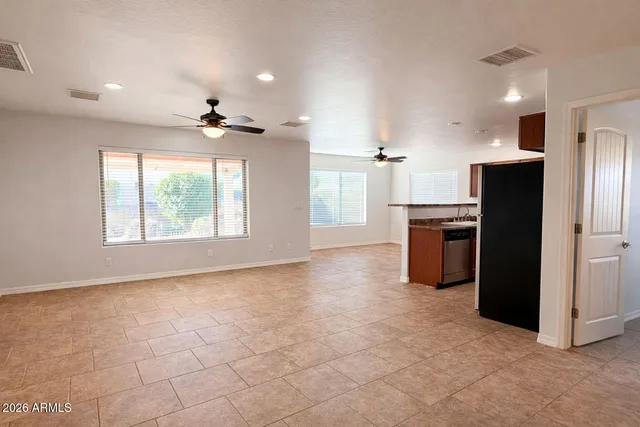 a view of a kitchen with a sink a refrigerator and window