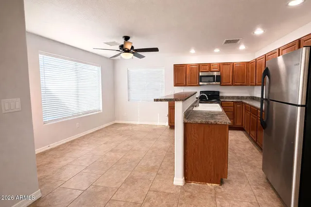 a kitchen with refrigerator cabinets and a sink