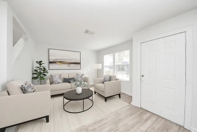 a living room with furniture and a large window