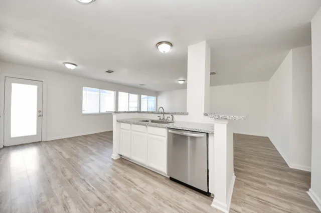 a kitchen with a sink stove and refrigerator