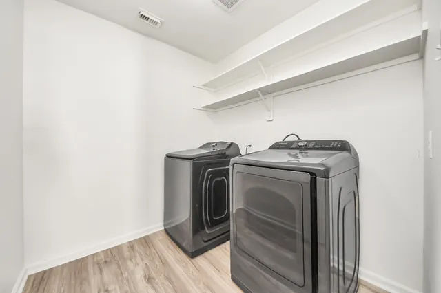 a kitchen with granite countertop white cabinets and stainless steel appliances