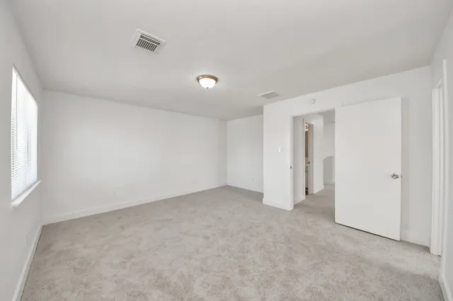 a bathroom with a sink a toilet and a window