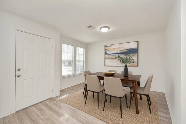 a view of a dining room with furniture and wooden floor