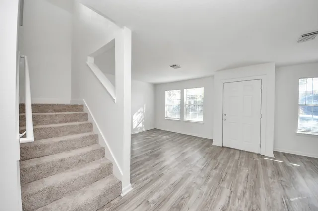 a view of an entryway with wooden floor and windows
