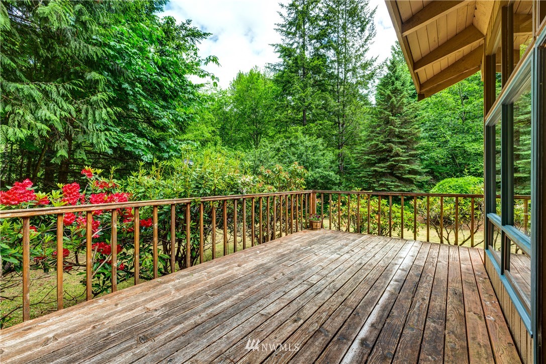 1309 Old Samish Road Bellingham, WA 98229 - Photo 22 of 40 a balcony with wooden floor and trees in the back
