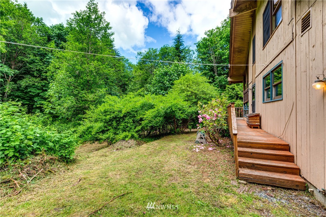 1309 Old Samish Road Bellingham, WA 98229 - Photo 26 of 40 a view of a pathway of a house with plants and wooden fence