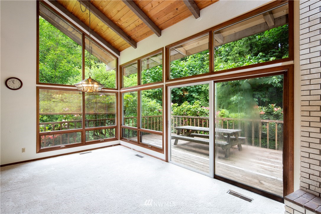 1309 Old Samish Road Bellingham, WA 98229 - Photo 8 of 40 a view of an empty room with wooden floor and a balcony