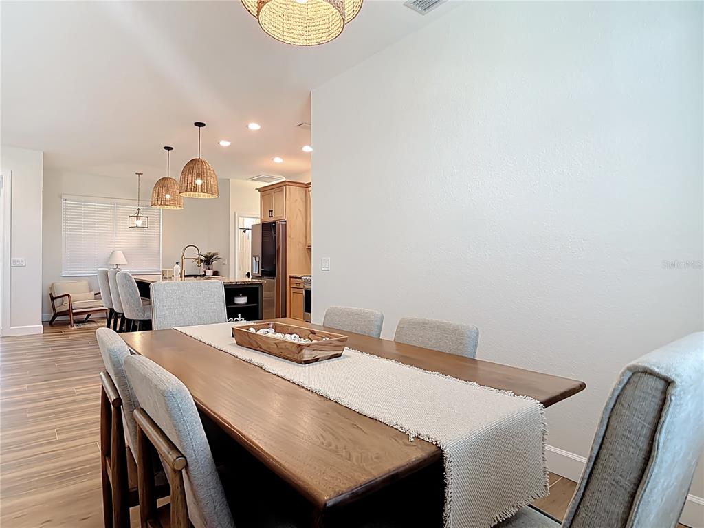 26 Medalist Way Rotonda West, FL 33947 - Photo 16 of 63 a kitchen with a table and chairs in it