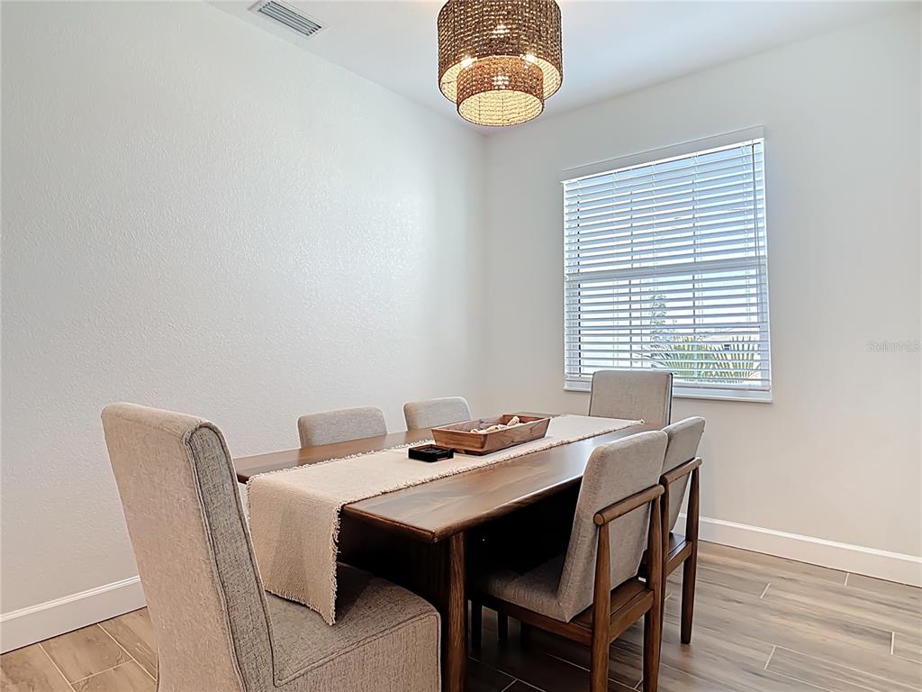 26 Medalist Way Rotonda West, FL 33947 - Photo 20 of 63 a dining room with furniture and window