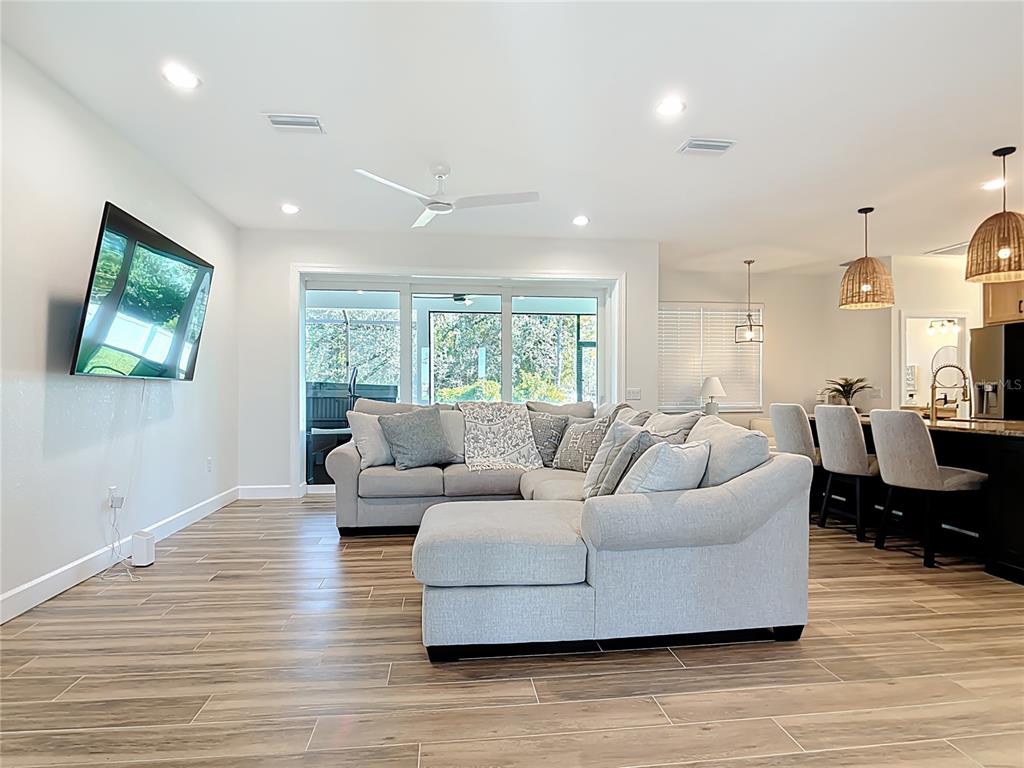 26 Medalist Way Rotonda West, FL 33947 - Photo 23 of 63 a living room with furniture wooden floor and a flat screen tv