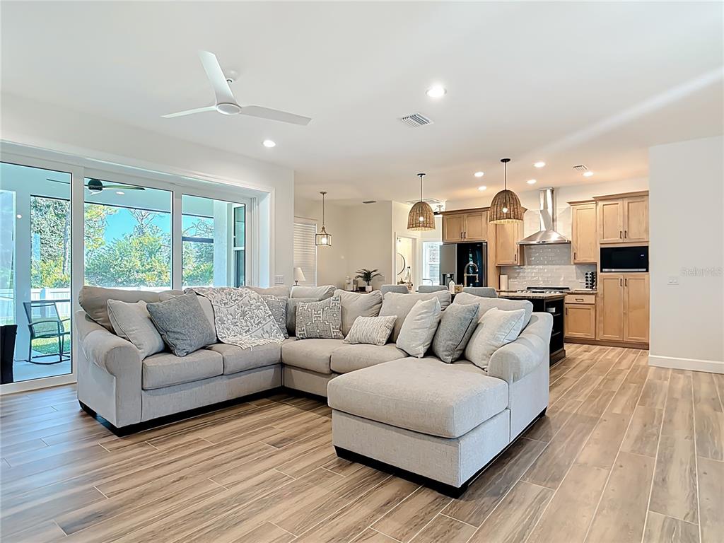 26 Medalist Way Rotonda West, FL 33947 - Photo 24 of 63 a living room with furniture and a large window