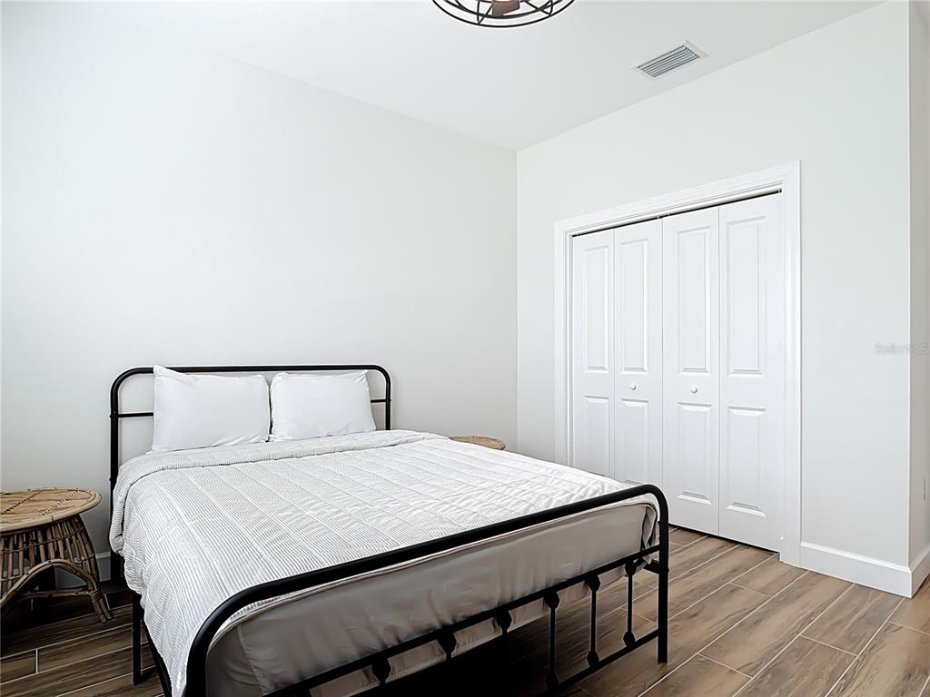 26 Medalist Way Rotonda West, FL 33947 - Photo 36 of 63 a bedroom with a bed and a table