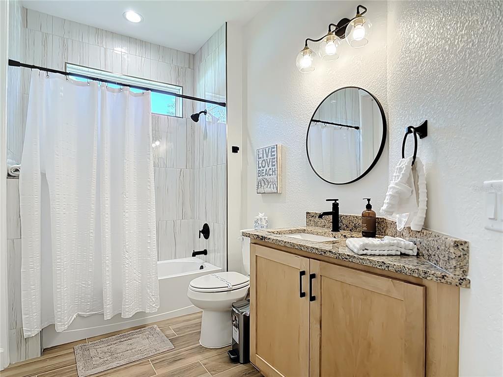 26 Medalist Way Rotonda West, FL 33947 - Photo 39 of 63 a bathroom with a granite countertop sink toilet and shower