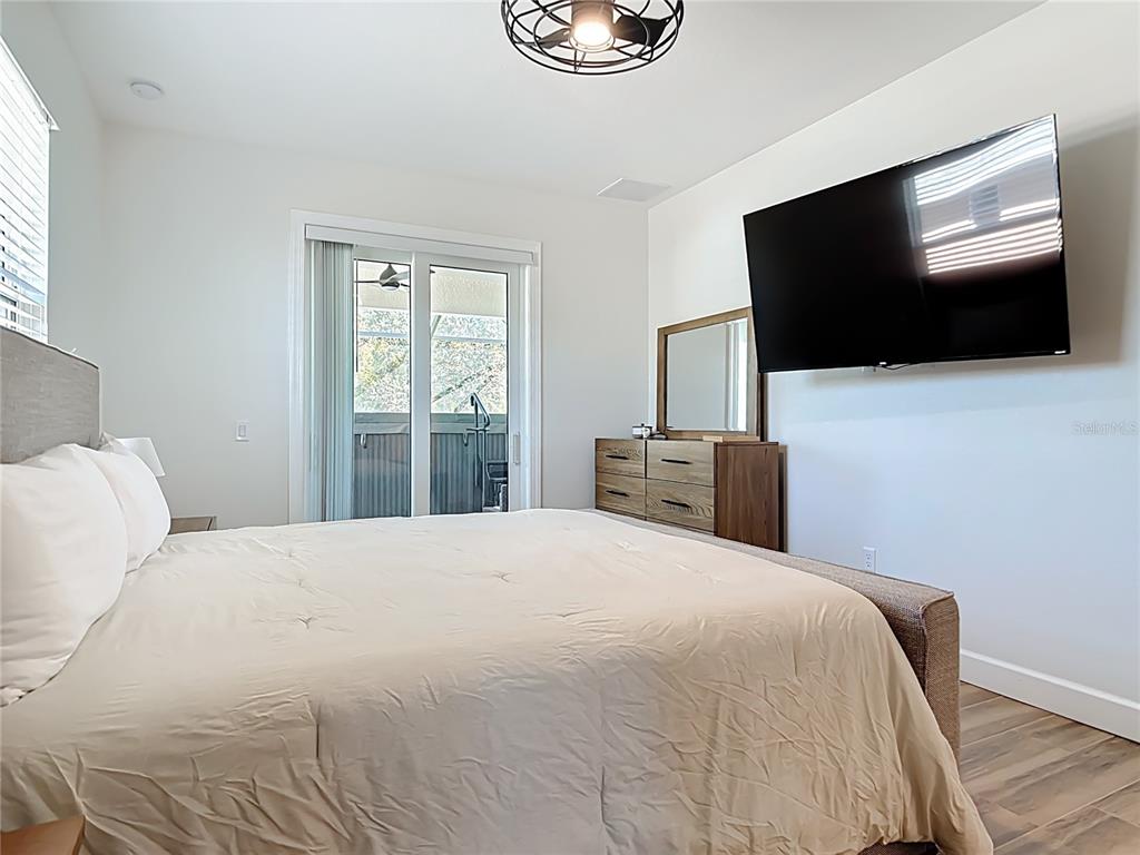 26 Medalist Way Rotonda West, FL 33947 - Photo 40 of 63 a bedroom with a bed and a flat screen tv