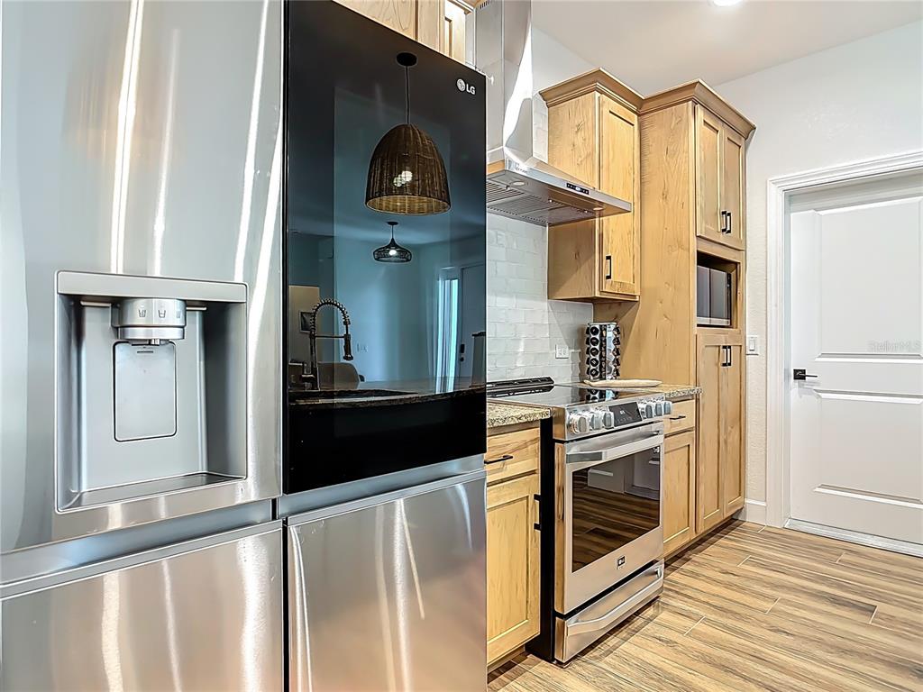 26 Medalist Way Rotonda West, FL 33947 - Photo 4 of 63 a kitchen with stainless steel appliances granite countertop a stove and a refrigerator