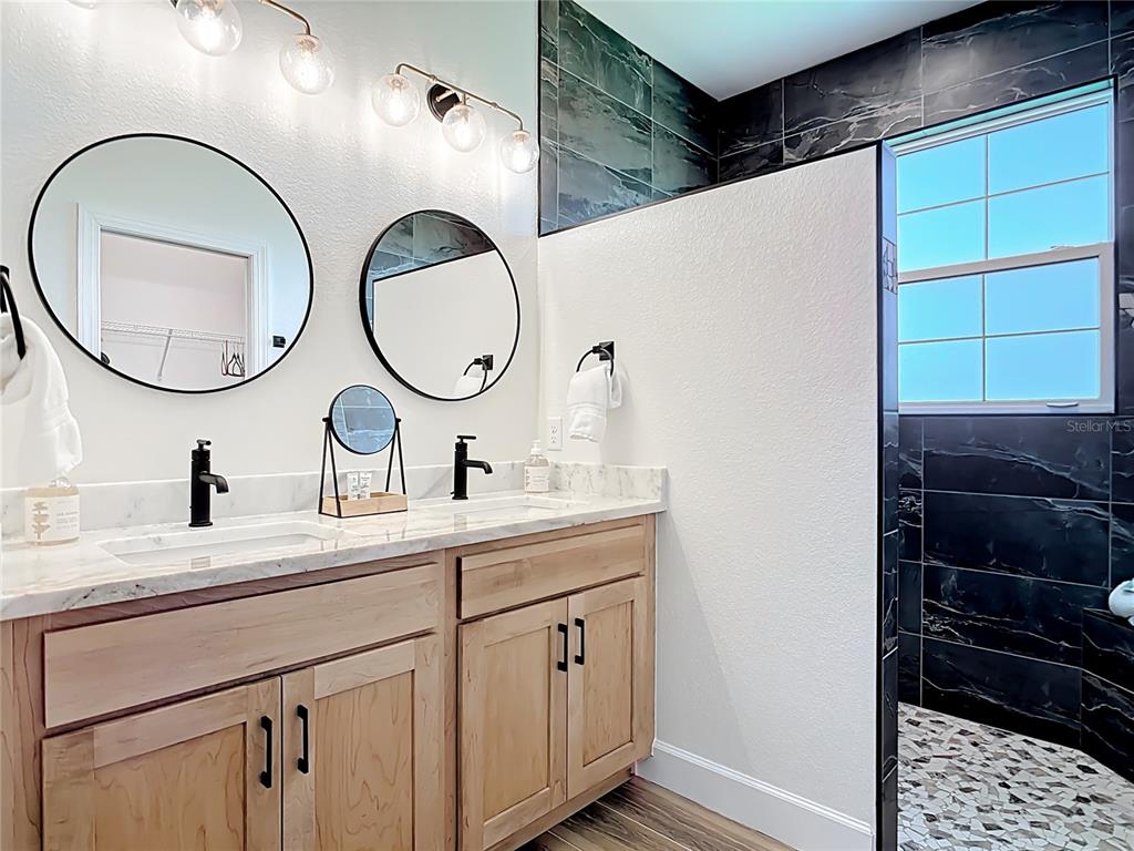 26 Medalist Way Rotonda West, FL 33947 - Photo 44 of 63 a bathroom with a double vanity sink and a mirror