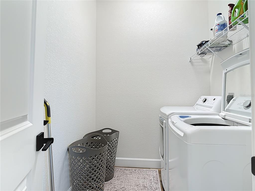 26 Medalist Way Rotonda West, FL 33947 - Photo 46 of 63 a utility room with dryer and washer