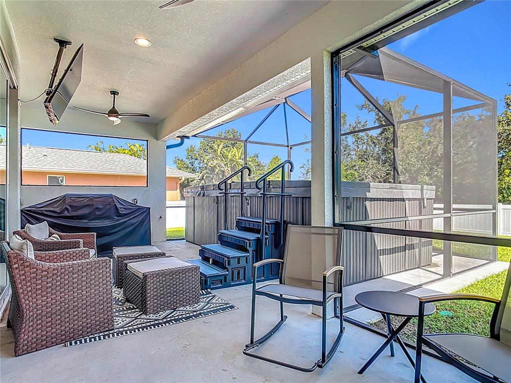 26 Medalist Way Rotonda West, FL 33947 - Photo 49 of 63 a living room with furniture a rug and a large window